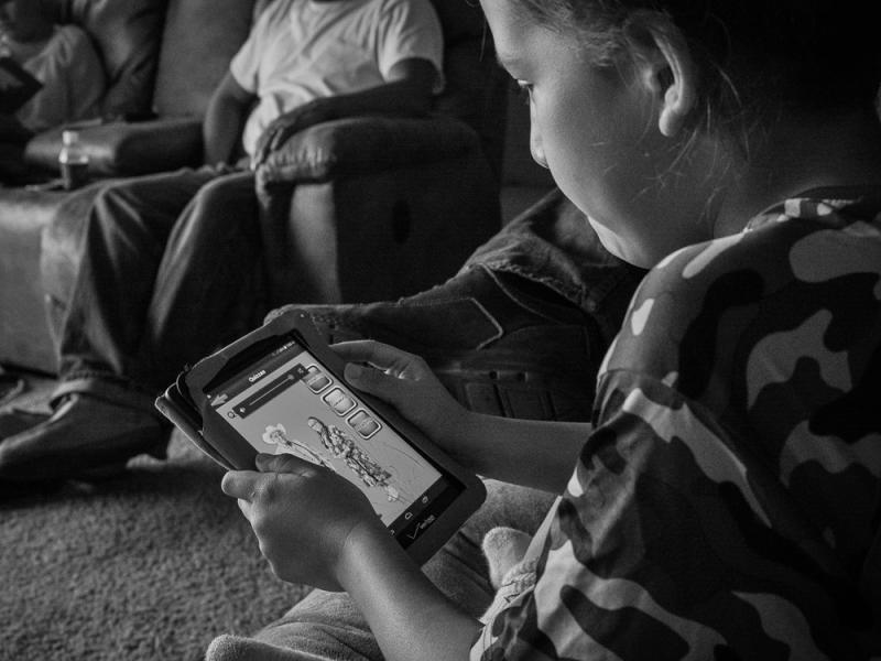 Luke  Brien Uses an App to Learn His Crow Language, Arlee, Flathead Reservation, Montana, 2016 by Sue Reynolds