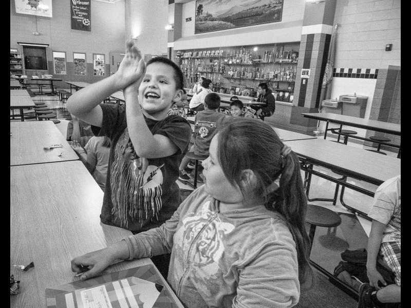 Michael Shoots Hoops with Lo LaPlant in the After School Program at Wakpala Public School, Standing Rock Reservation, South Dakota, 2015 by Sue Reynolds