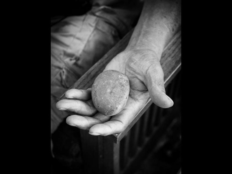 Emmett Martin Holding a Rock with a Story, Mobridge, South Dakota, 2015 by Sue Reynolds