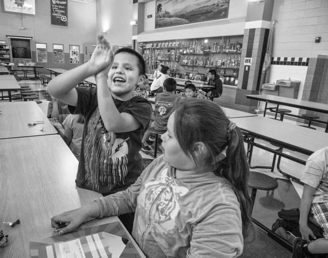 Michael Shoots Hoops with Lo LaPlant in the After School Program at Wakpala Public School, Standing Rock Reservation, South Dakota, 2015 by Sue Reynolds